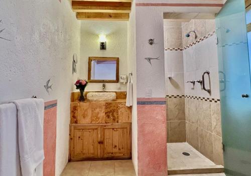 a bathroom with a shower and a sink at Hacienda Soltepec Suites Campo de Golf in Huamantla