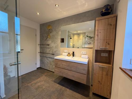 a bathroom with a sink and a mirror at Ferienwohnung Andreas in Holzkirchen