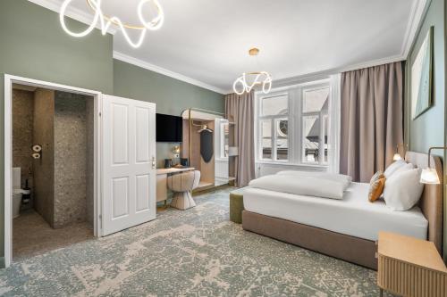 a hotel room with a bed and a bathroom at HOME1 - Lumes Boutique Hotel in Vienna