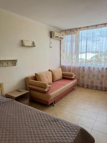 a living room with a couch and a window at Promenad San in Dobrovelychkivka
