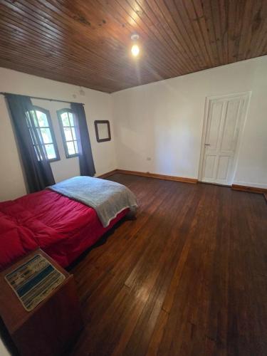 a bedroom with a bed and a wooden ceiling at El descanso in Veronica