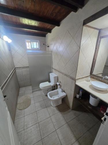 a bathroom with two toilets and a sink at El descanso in Veronica