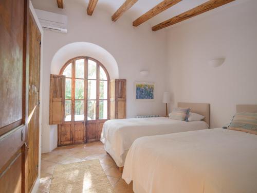 a bedroom with two beds and a window at Can 'Jeson in Deia