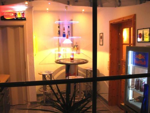 a room with a table and stools with candles at Ferienhaus Bundenthal in Bundenthal