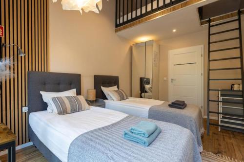 a bedroom with two beds with towels on them at Krokodyl Sport&Spa in Mielno