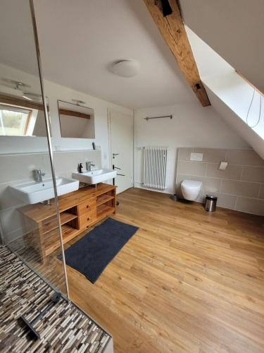 a bathroom with two sinks and a toilet at Lauberhof in Trippstadt