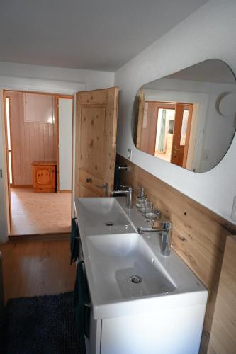 a bathroom with a sink and a mirror at Ferienwohnung "Posta Veglia" - Cumbel in Cumbels