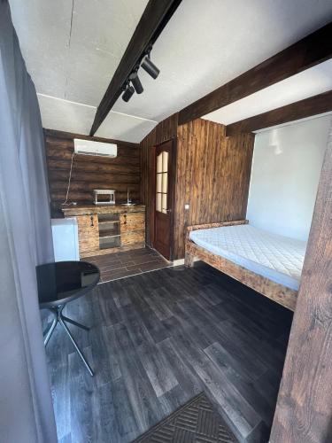 a room with a bed and a desk in it at Shulgivka in Shulʼgovka