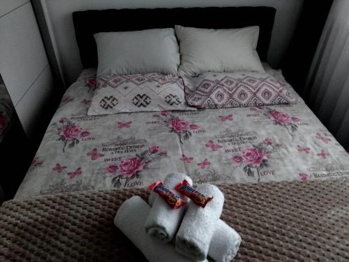 two stuffed animals are sitting on a bed at Apartman Veka KV in Kraljevo