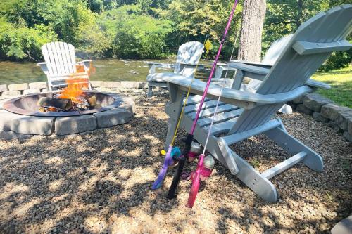 two chairs and a fire pit in a yard at Mill Stream Cottage in Pigeon Forge