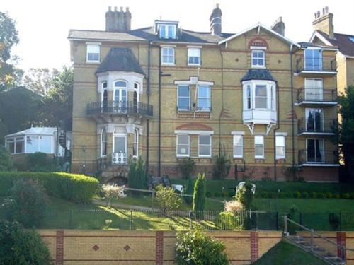 a large house with a fence in front of it at Villa Rothsay Hotel in Cowes