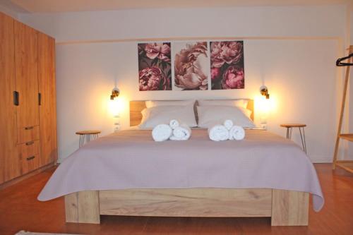 a bedroom with a bed with two towels on it at Loft by the sea in Amfilochia