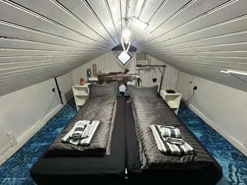 a room with two beds in a tent at Chic Townhouse - Views Telescope Balcony BBQ in Siglufjörður