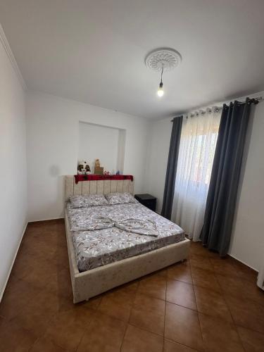 a bedroom with a bed in the corner of a room at Villa Gjeci Tale in Tale
