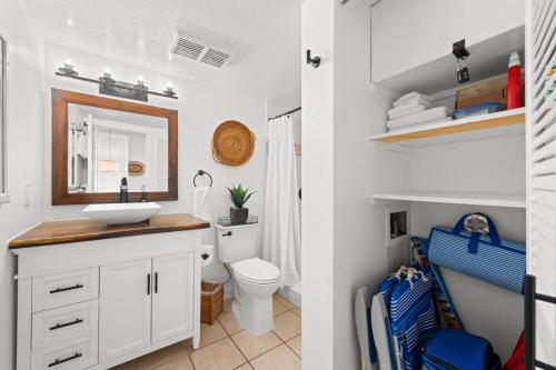 a white bathroom with a sink and a toilet at Kona Mansions#B217 Beautiful unit with Ocean view! in Kailua-Kona