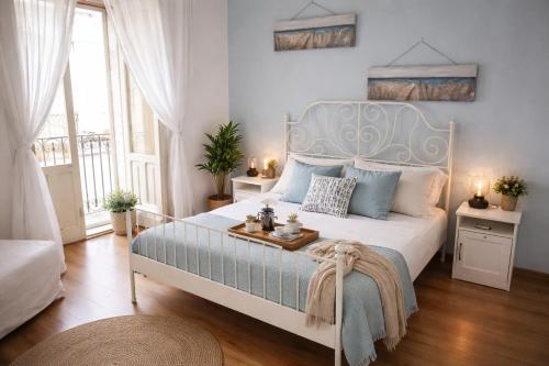 a bedroom with a large bed with a blue headboard at Lùrooms- Guesthouse in Noto in Noto