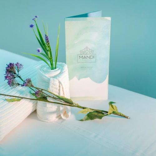 a box and a vase with flowers on a table at Gran Bourbon Hotel Asuncion in Asuncion
