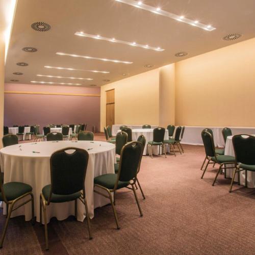 a conference room with tables and chairs and a podium at Gran Bourbon Hotel Asuncion in Asuncion