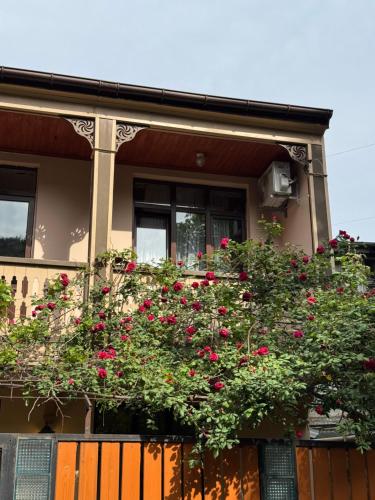 a building with a bunch of red flowers on it at Hotel "Tbilisi Tales" in the heart of the Old City in Tbilisi City