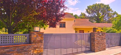 a house with a fence in front of it at TRES TEULADES 8+1 in Castellnou de Bages