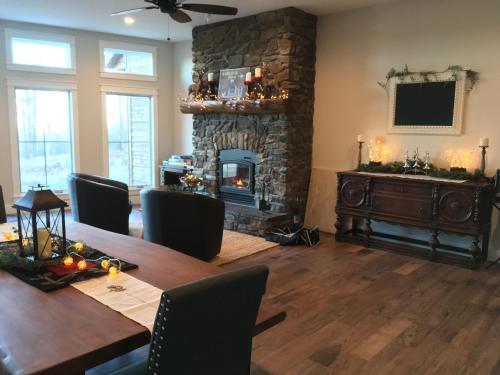 a dining room with a table and a stone fireplace at Timber Baron Inn in Bayfield