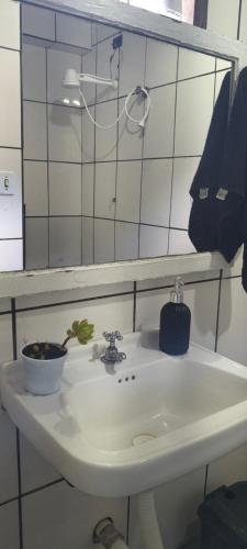 a bathroom sink with a mirror and a bowl on it at Hospedagem Maranata in Santo André