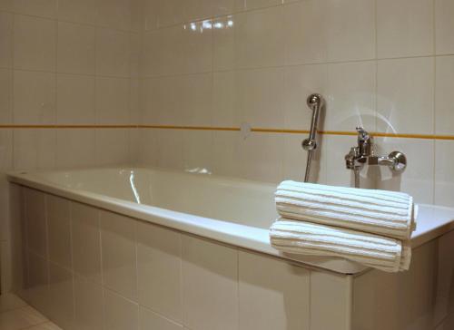 a bathroom with a bath tub with towels on it at Casa Nicole Aquileia in Aquiléia