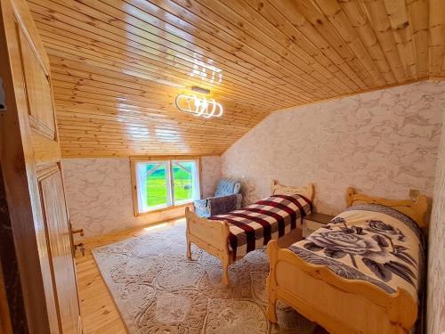 a bedroom with a bed and a couch in a room at Xinaliq Khinalig İzzet's Riverside Home Stay in Xınalıq
