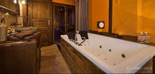 a large bathroom with a large tub and a sink at Ferienhaus-Sauna Pool Whirlpool in Grimma