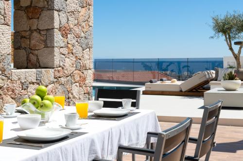 a table with food and drinks on a patio at Ortus Luxury Residence in Rhodes Town