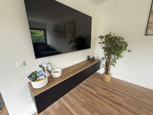 a living room with a large mirror on the wall at Ferienwohnung Bächle in Bad Peterstal