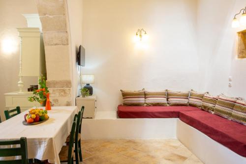 a room with a bed and a table with a red couch at Eligia home in Angouselianá