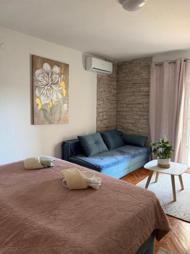 a living room with a bed and a couch at Muring Apartments in Tribunj