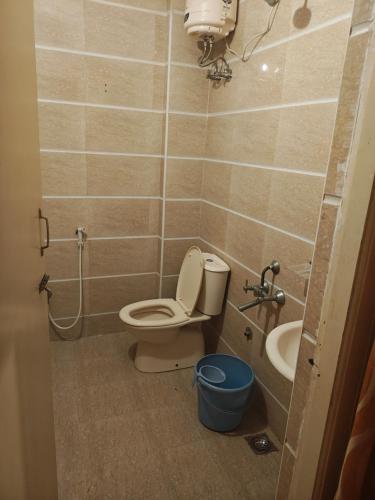 a bathroom with a toilet and a sink at skylink residency in Chennai