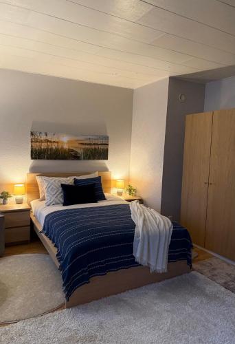 a bedroom with a large bed and two night stands at Andsuuria Apartment in Paide