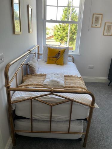 a bed in a room with a window at Willow Lodge in Kilham