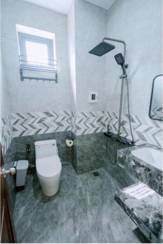a bathroom with a toilet and a sink at Moonlight House in Cu Lao Thu