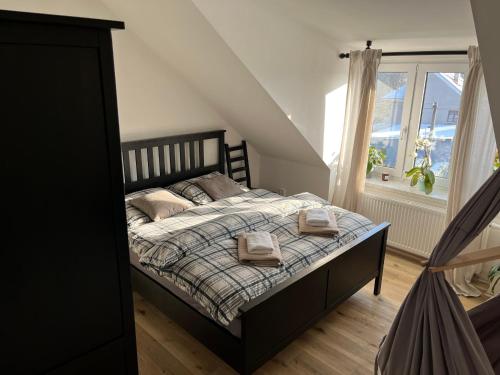 a bedroom with a bed with two towels on it at Penzion Lívanec in Horní Bezděkov