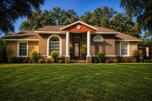 a house with a green lawn in front of it at Serene Mountain Retreat With Pool in Clermont