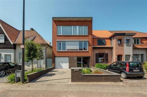 a house with a car parked in a parking lot at CoSY HOME in Mortsel
