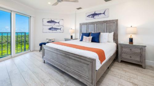 a bedroom with a large bed and a large window at Sunrise Oasis - Top Floor Ocean Pointe 2411 in Key Largo