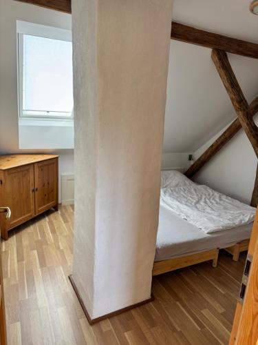 a small bedroom with a bed and a window at Chalupa u Otavy Horní Poříčí in Horní Poříčí