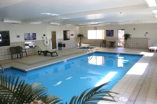 a large pool with blue water in a building at Crystal Inn Hotel & Suites - Great Falls in Great Falls