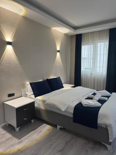 a bedroom with a large bed and a window at Blue class otel in Atakum