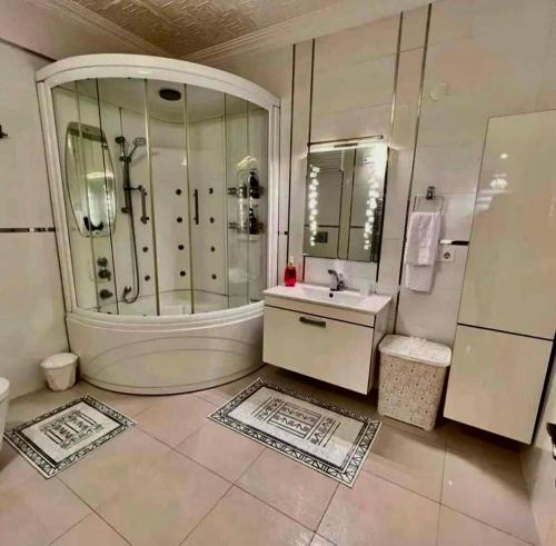 a bathroom with a tub and a sink and a shower at Seafront Apartment Rize - Ardeşen in Ardeşen
