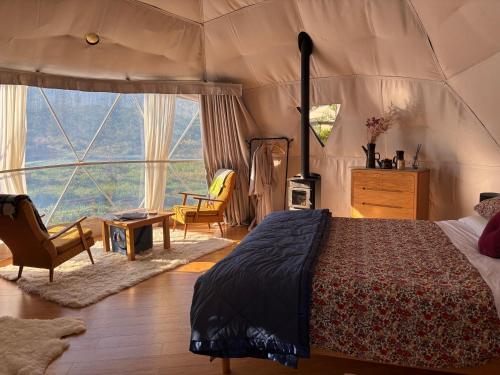 a bedroom with a bed in a tent at Takahuri Glamping Domes in Whanganui