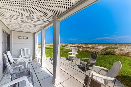 a patio with chairs and a view of the ocean at #1131 The Mermaid Pad in Gulf Highlands