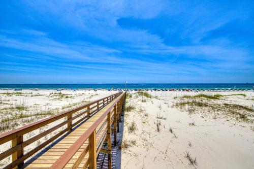 a wooden boardwalk leading to the beach with the ocean at Plantation East #4504 in Gulf Highlands