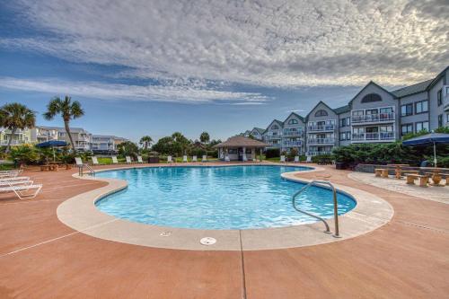 a swimming pool in the middle of a resort at Plantation West #1261 in Gulf Highlands