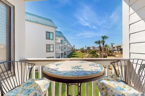 a table and chairs on a balcony with a view at Plantation West #1261 in Gulf Highlands